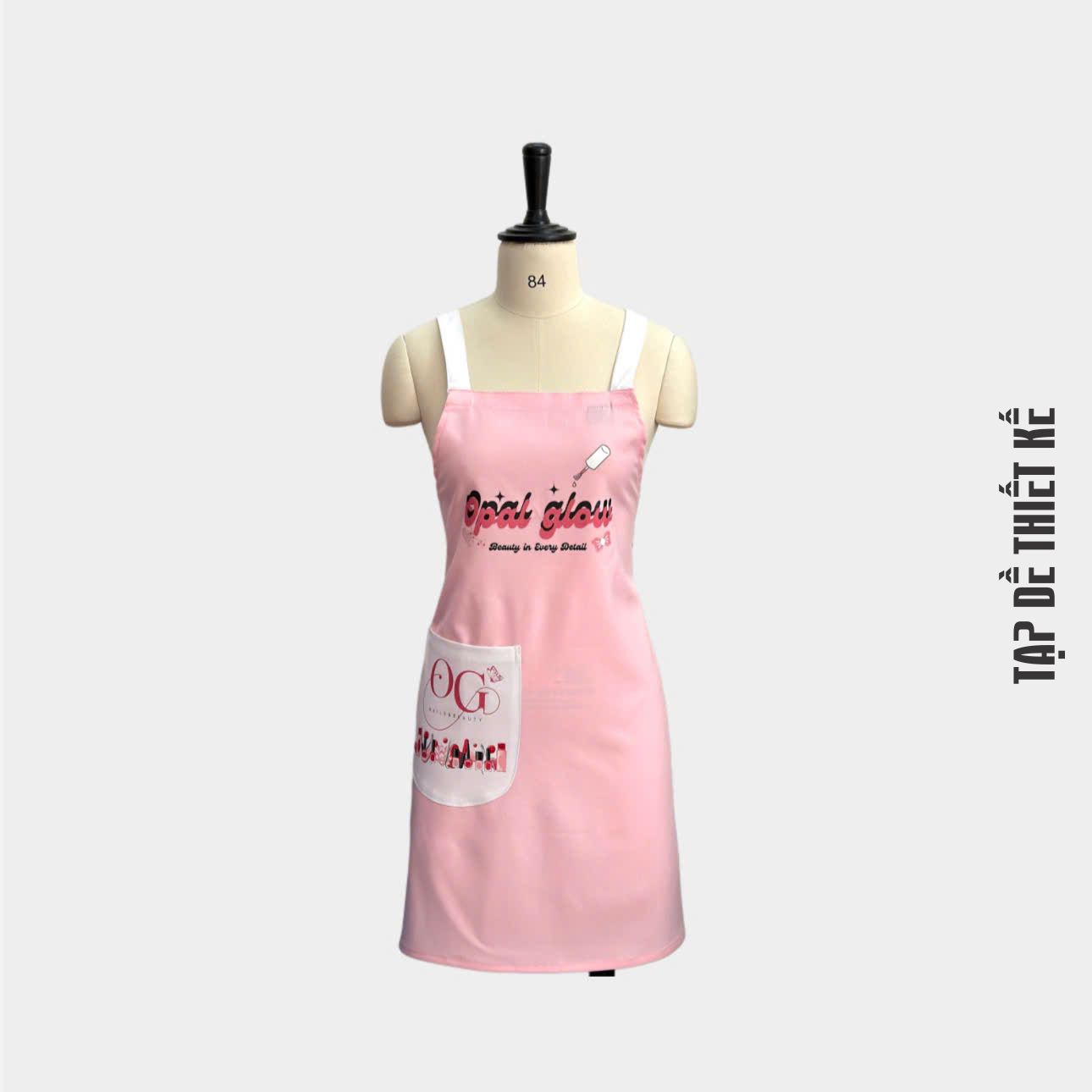 Tạp dề nails màu hồng có in logo thương hiệu tiệm nail.